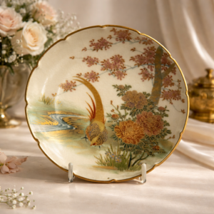 Piatto Satsuma giapponese in ceramica finemente decorata, Giappone, periodo Meiji (fine XIX – inizi XX secolo)Il cavetto presenta una raffinata scena naturalistica con fagiano tra crisantemi e rami fioriti, resa con minuziosa policromia e ricchi dettagli in oro. Bordo sagomato e dorato. Al verso marchio Satsuma con iscrizione Hand Painted, indicativo di produzione destinata al mercato occidentale. Esemplare decorativo di qualità, rappresentativo della tradizione pittorica Satsuma.